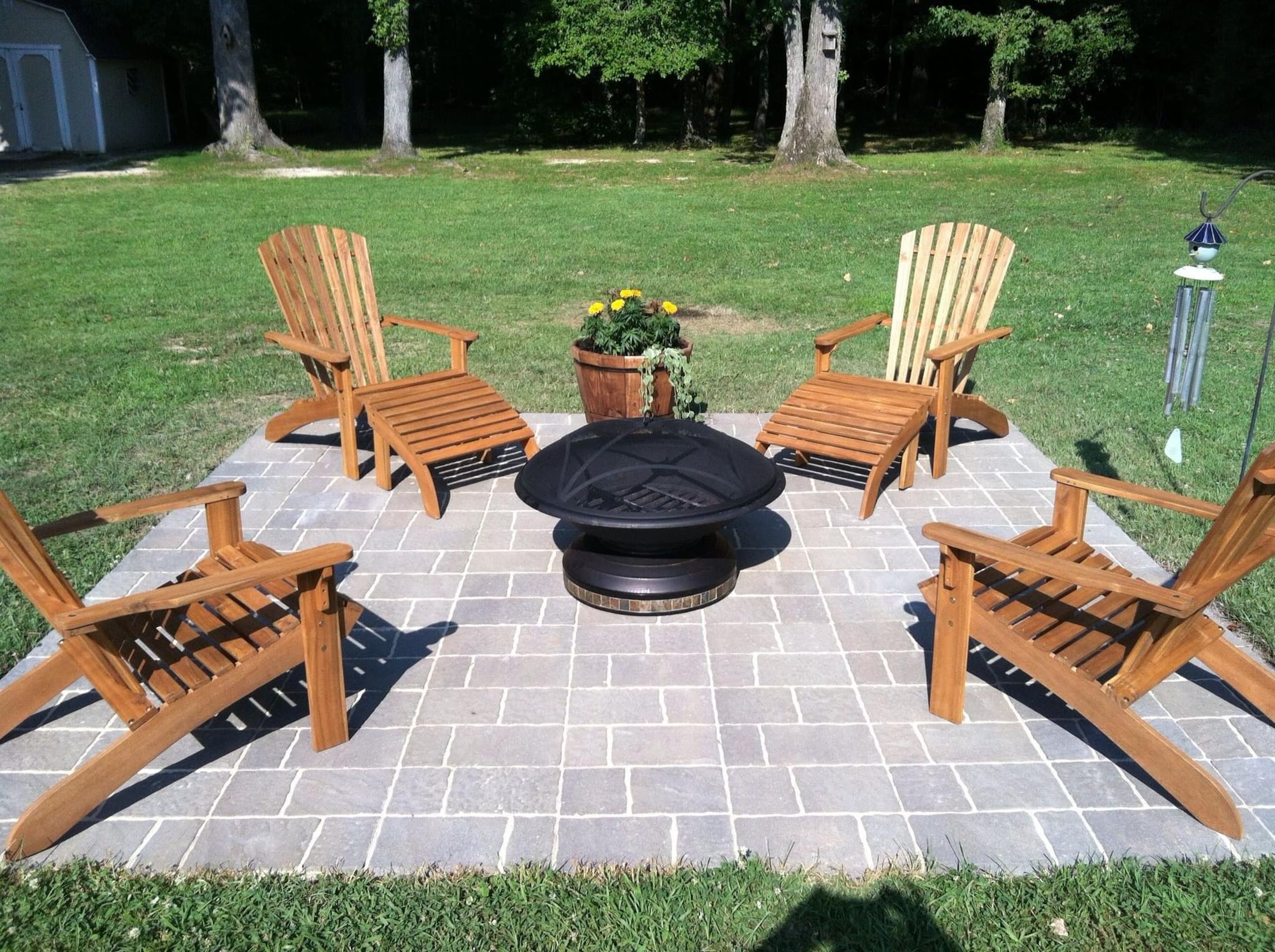 Paver patio with a fire pit and seating built by Green Apple in a Halifax backyard