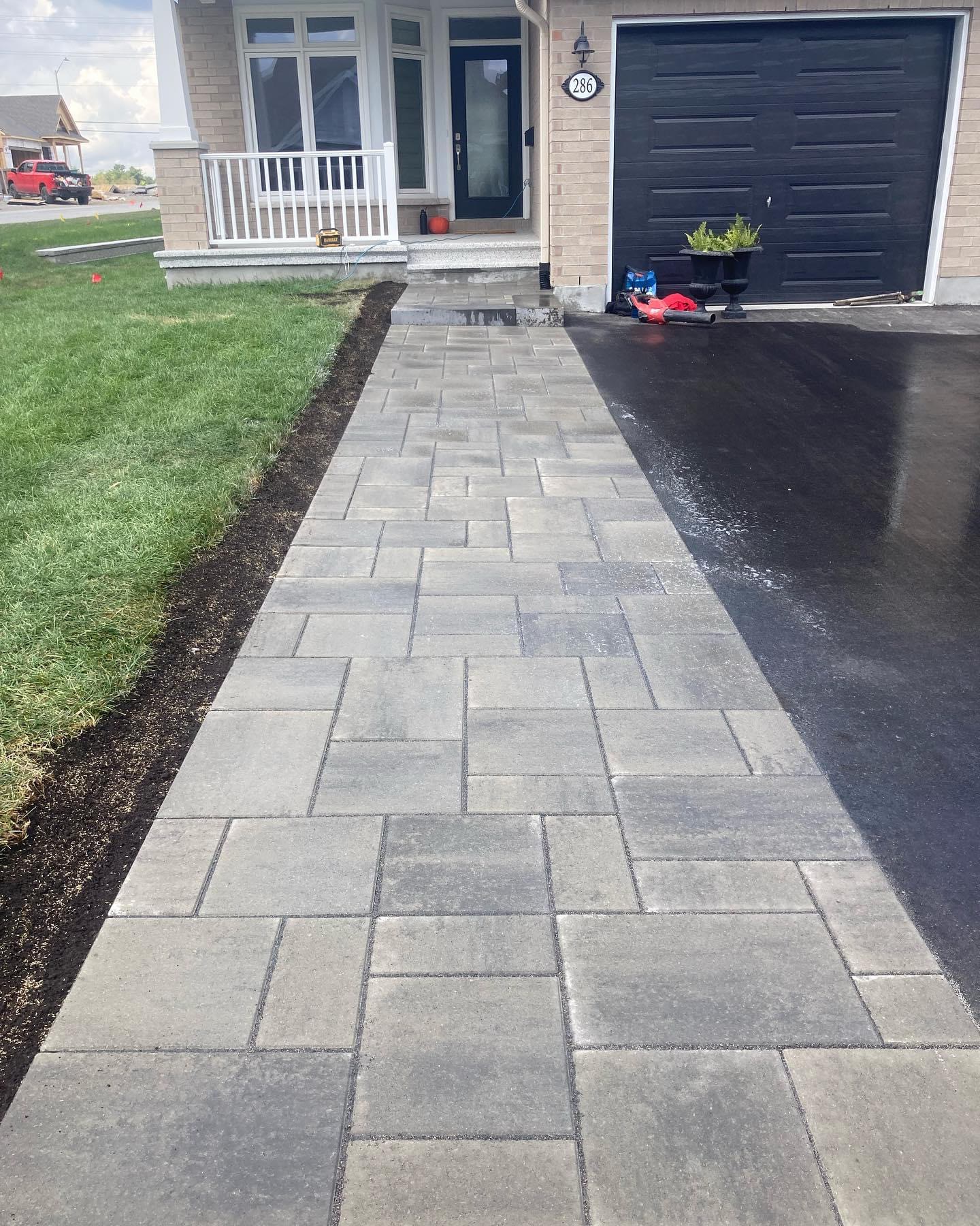 Paver walkway leading from driveway to a front door in Halifax